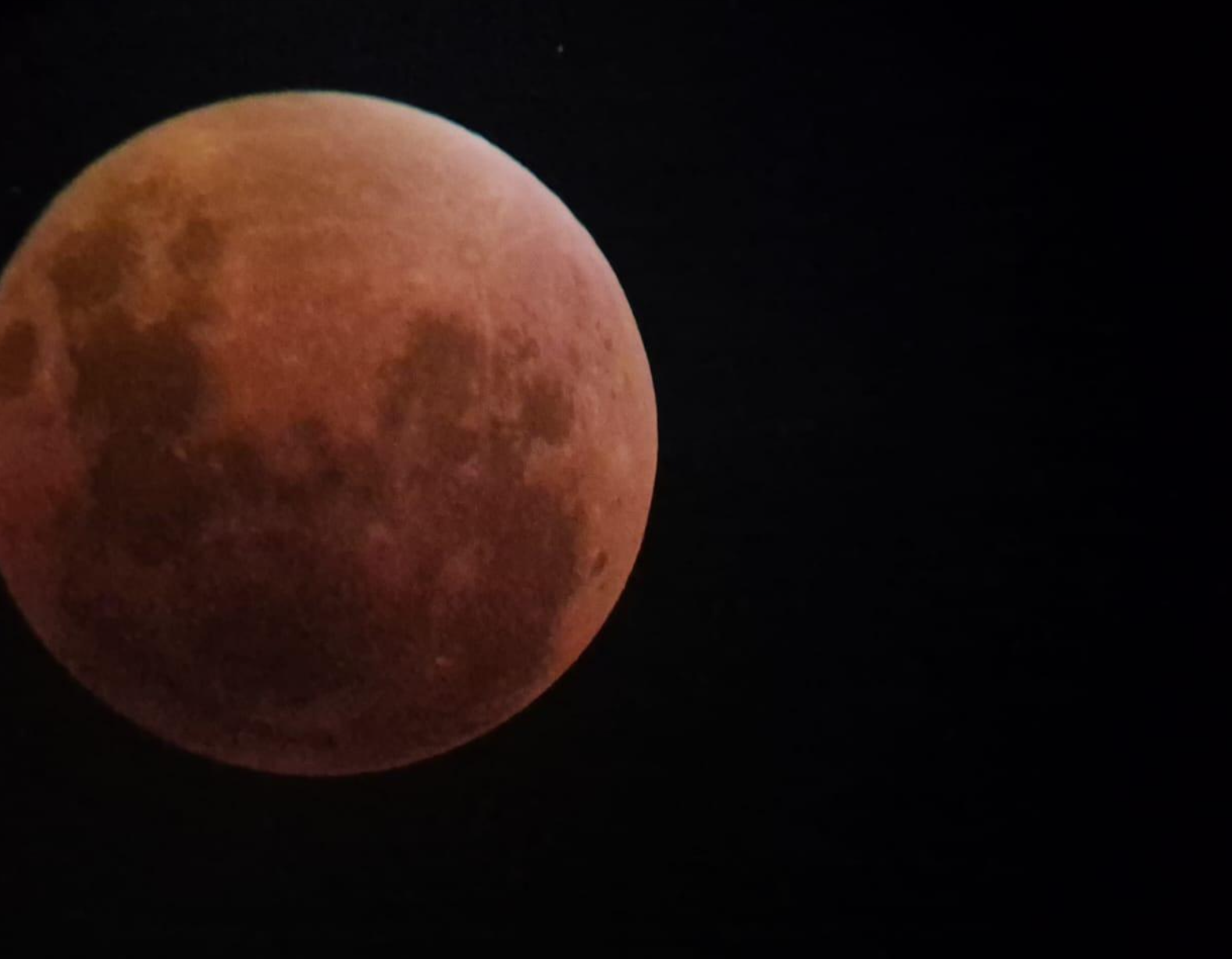 Blood-red moon against a dark sky during a lunar eclipse
